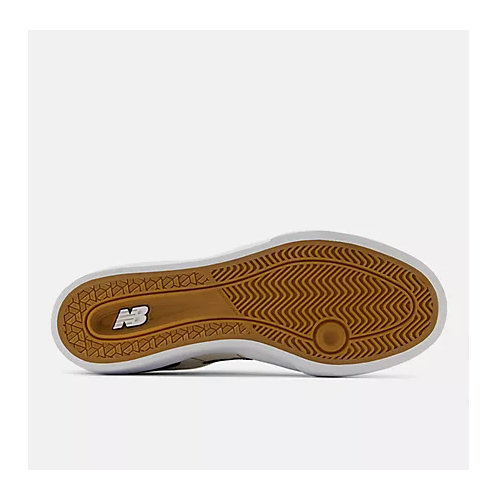 The outsole of a New Balance sneaker, showing a brown textured tread pattern and the white 'NB' logo on the heel, set against a light gray background.