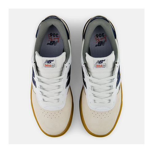 A pair of New Balance 306 sneakers shown from a top-down view. The shoes feature white mesh uppers, off-white suede overlays, navy blue side stripes, a gray collar, and a brown gum sole.