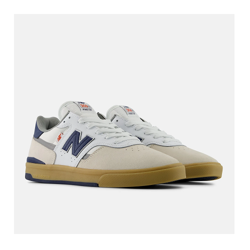 A pair of New Balance 306 cup sole skate shoes in white, beige, navy, and gum brown, shown against a light gray background.