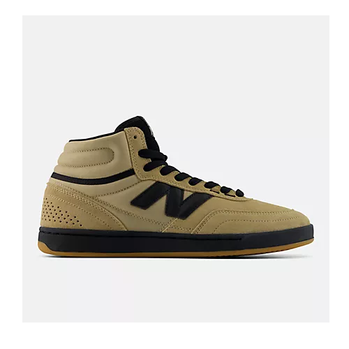 A New Balance mid-top skate shoe in tan and black, shown from the side against a light gray background.