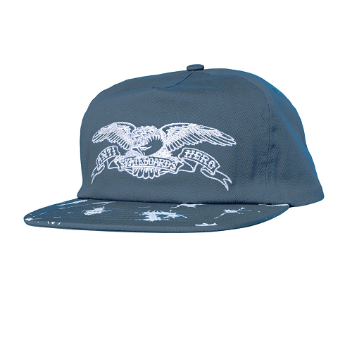 A slate blue snapback cap featuring a white embroidered eagle and banner graphic on the front with the text Antihero Skateboards