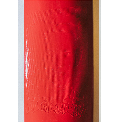 A close up photo of a bright red FA skateboard deck with an embossed graphic and FA logo on a white background. 