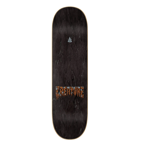 Top of a black stained skateboard with the creature logo. 