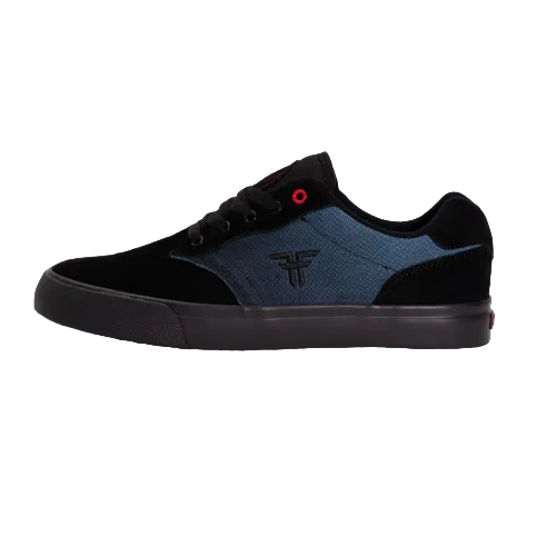 Side view of black and dark blue Fallen footwear The Goat shoe. 