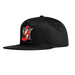 A black flat-brim snapback cap featuring a rectangular embroidered patch on the front with a stylized red, white, and green wizard.