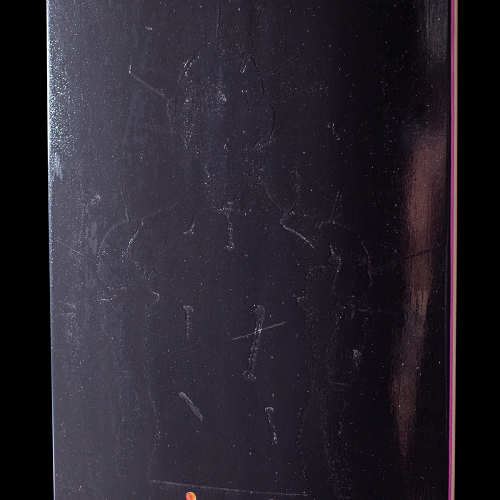 Close up picture of the embossed graphic on a black Hockey skateboard.