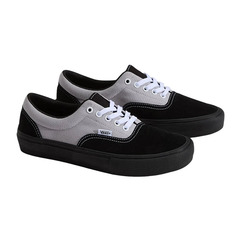 A pair of Vans Era sneakers in black and light gray suede, featuring white laces and a thick black platform sole, shown against a plain white background.