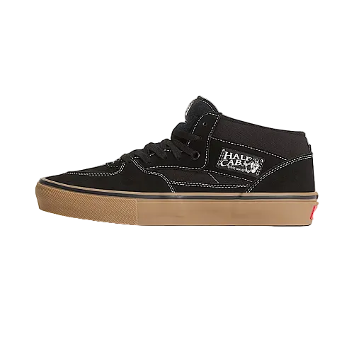 Black high-top sneaker with tan sole on a white background