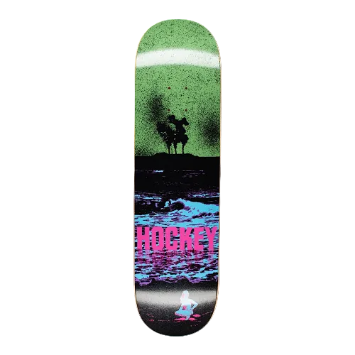A black, blue and green Hockey skateboard featuring an apocalyptic scene of woman sunbathing by water and a nuclear plant in the background. 