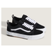 A pair of black and white Vans Old Skool Wafflecup sneakers shown from a three-quarters angle against a light beige background.