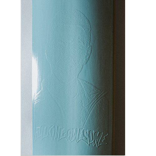 Close up picture of a light blue FA skateboard with an embossed graphic and logo on a white background. 