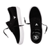 A pair of black low-top skate shoes with white soles, shown from the side and top views on a plain white background. The shoes feature a white stylized logo on the side and tongue, and a larger black-and-white logo on the insole.