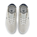 A pair of low-top sneakers shown from a top-down view on a white background. The shoes feature off-white suede uppers with white laces, white soles, and dark navy blue accents on the collar lining and side details.