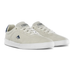 A pair of low-top skate shoes in light beige suede with white laces, white rubber soles, and navy blue accents on the heel tab and side logo, shown against a plain white background.